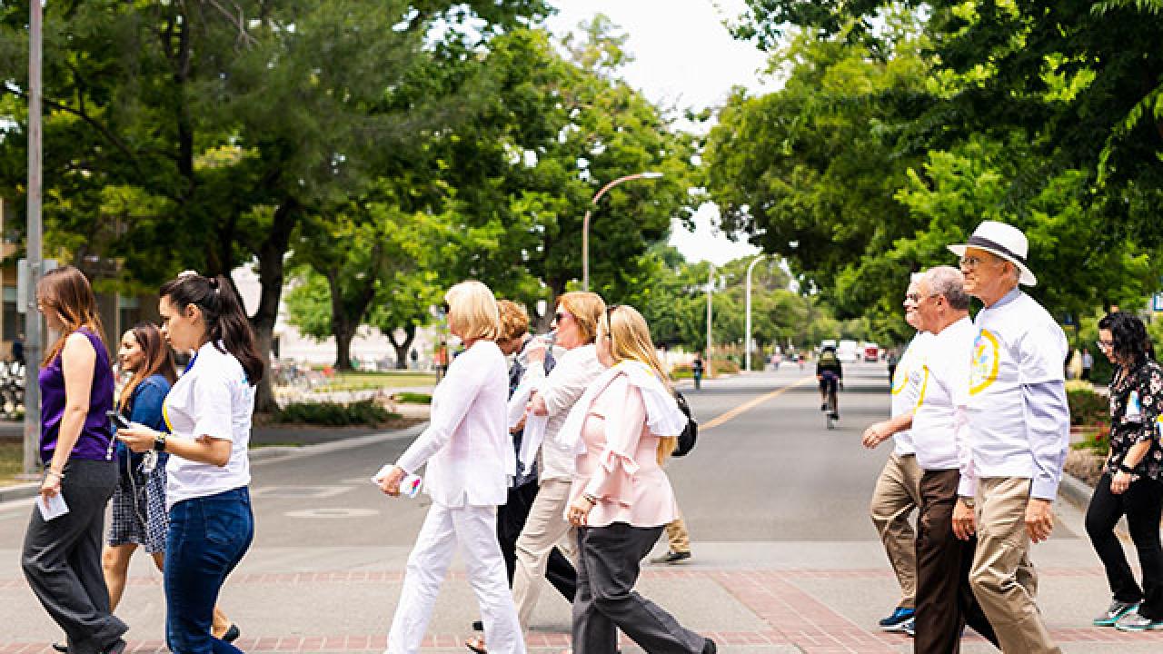 Photo of diverse group of people in a crosswalk.