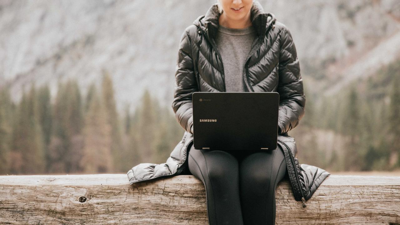 Woman with laptop computer outdoors